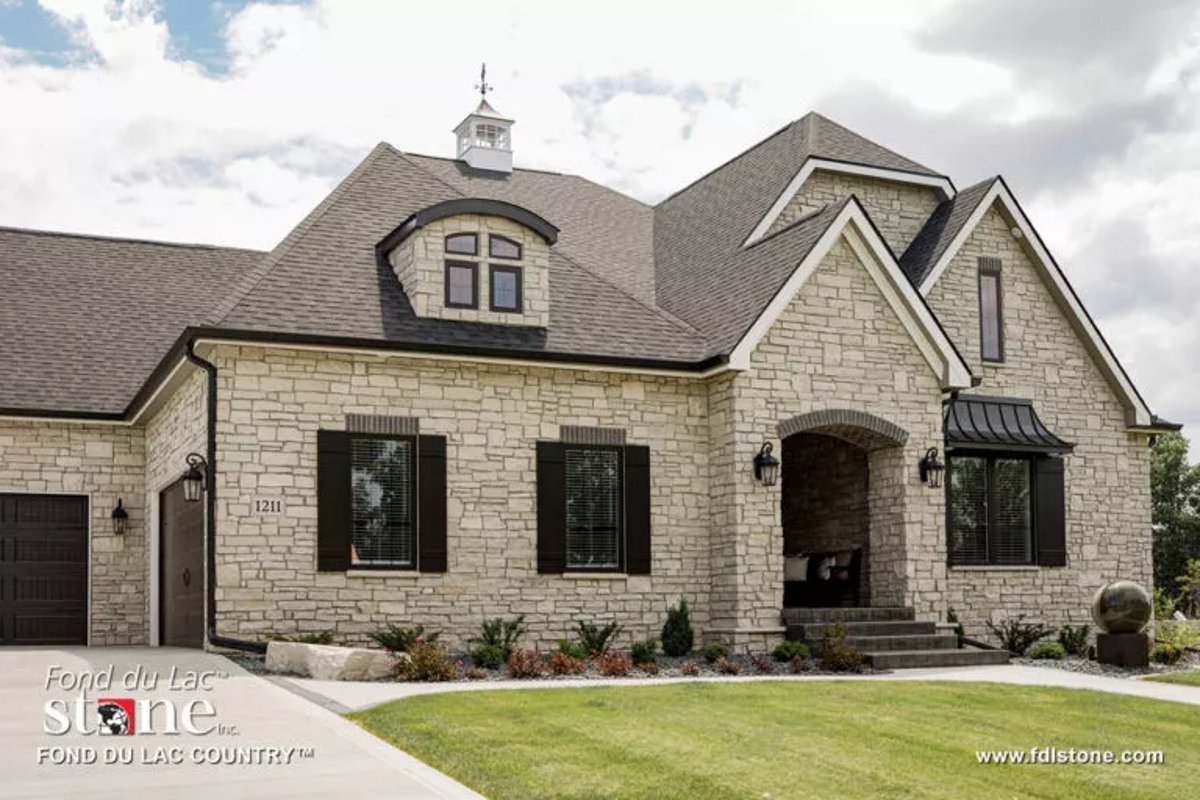 house with an exterior stone veneer of produced by Fond du Lac Natural Stone™